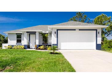 Charming single-story home with a two-car garage, freshly manicured lawn, and vibrant curb appeal at 6245 Alhambra Ave, North Port, FL 34291