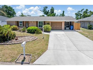 Charming single-story home featuring a well-manicured front yard and extended driveway at 218 Parkview Dr, Venice, FL 34293