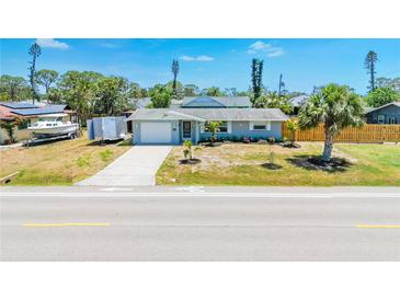 Charming single-story home with a well-manicured lawn, a one-car garage, and a freshly sealed driveway at 3319 Shamrock Dr, Venice, FL 34293