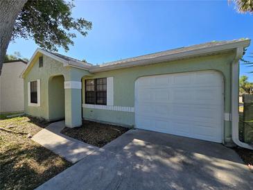 Charming single-story home with an attached garage and well-maintained front yard at 19583 Kapok Ct, Port Charlotte, FL 33952