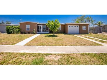 Charming single-story home featuring a well-maintained front yard and an attached single-car garage at 159 Godfrey Ne Ave, Port Charlotte, FL 33952