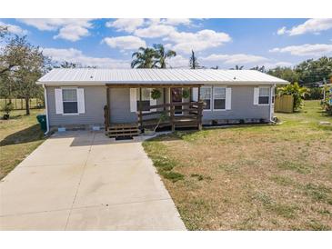 Charming single story home with a wooden porch and well-maintained lawn at 200 Summerset Dr, Punta Gorda, FL 33982