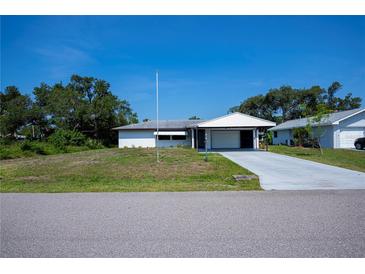 Charming single-story home featuring a carport and a concrete driveway at 2113 Barksdale St, Port Charlotte, FL 33948