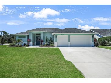 Charming single-story home with a well-manicured lawn and a two-car garage at 25273 Paraguay St, Punta Gorda, FL 33983