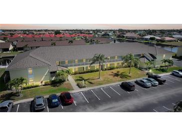 Two story yellow apartment complex with tile roof and parking at 4000 E Bal Harbor Blvd. E. #211 # 211, Punta Gorda, FL 33950