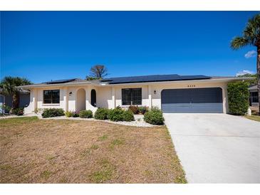 Charming single-story home with well-maintained landscaping and a two-car garage at 4339 Boggs St, Port Charlotte, FL 33948