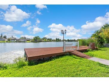 Waterfront property with personal dock and walkway on a sunny day at 6604 Ranger Dr, Tampa, FL 33615