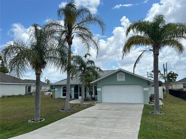Charming single-story home with a well-manicured lawn and swaying palm trees at 16072 Galiano Ct, Punta Gorda, FL 33955
