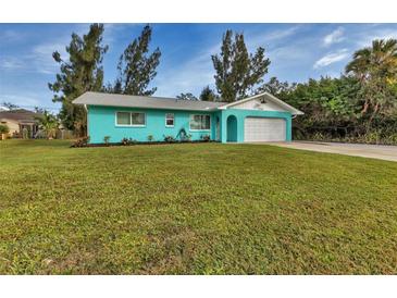 Charming turquoise single-story home featuring a well-manicured lawn and attached two-car garage at 20238 Banner Ave, Port Charlotte, FL 33952