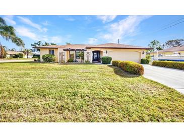 Single-story home featuring a well-manicured lawn and landscaping at 3663 Sterling Rd, Venice, FL 34293