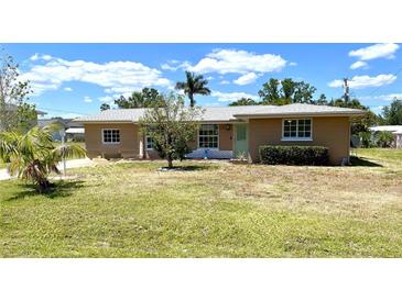 Charming single-story home with well-maintained lawn and mature landscaping at 700 Dolphin Pkwy, Punta Gorda, FL 33950