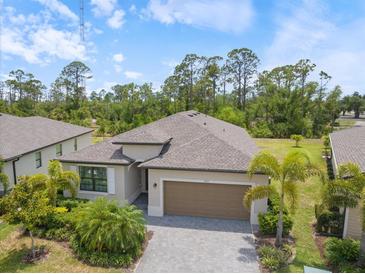 Well maintained home with paver driveway, two car garage, and mature landscaping in a beautiful neighborhood at 1993 E Isles Rd, Port Charlotte, FL 33953