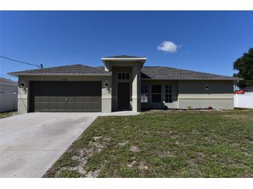 Inviting single-story home with a well-manicured lawn and neutral exterior paint at 2250 Homestead Cir, North Port, FL 34286