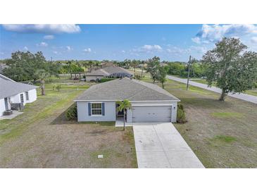 Charming single-story home featuring a well-manicured lawn and attached two-car garage in a quiet neighborhood at 27306 Deep Creek Blvd, Punta Gorda, FL 33983