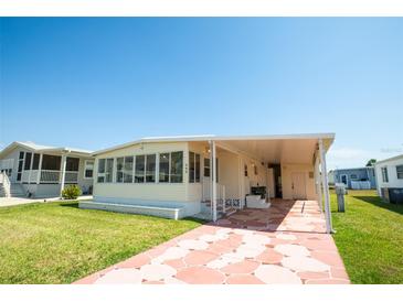 Inviting single-story home with a covered carport and screened porch at 643 Blackburn Blvd, North Port, FL 34287