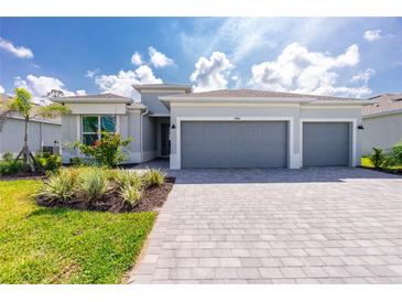Beautiful single-story home with a three-car garage and well-maintained landscaping at 8488 Saint Kitts Cir, Englewood, FL 34224