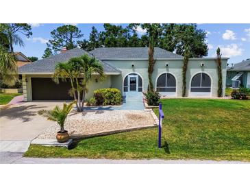 Charming single-story home with a well-manicured lawn, lush landscaping, and an attached two-car garage at 22498 Westchester Blvd, Punta Gorda, FL 33980