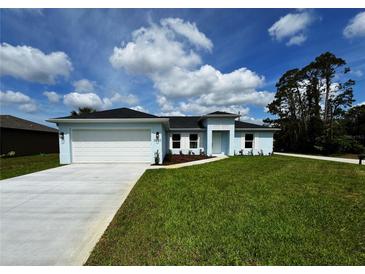 Charming single-story home with a well-manicured lawn, bright facade, and a two-car garage at 3560 Elias Cir, North Port, FL 34288