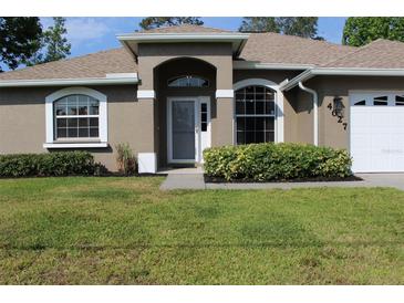 Well maintained single story home with lush landscaping and beautiful lawn at 4027 Quaker Ln, North Port, FL 34288