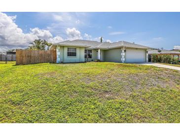 Charming single-story home with lush lawn, white trim, complemented by a well-maintained, two-car garage at 5331 Citadel Rd, Venice, FL 34293