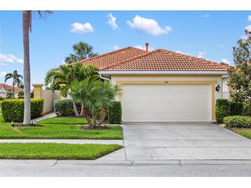 Charming single-story home with a two-car garage, tropical landscaping, and a red tile roof at 181 Padova Way # 19, Nokomis, FL 34275