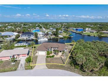 Beautiful waterfront home with lush landscaping and a private dock with ocean access in a desirable neighborhood at 18602 Ashcroft Cir, Port Charlotte, FL 33948