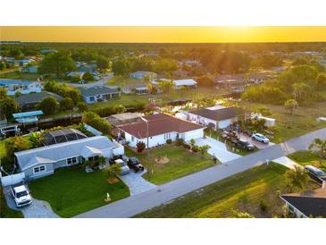 Beautiful aerial view of waterfront homes with well-maintained lawns and canal access at sunset at 3301 Santa Barbara Dr, Punta Gorda, FL 33983