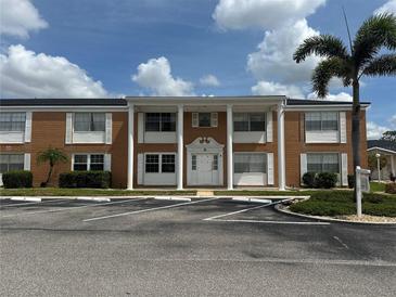 A brick building with columns and white trim, complemented by well-maintained landscaping at 4158 Tamiami Trl # A5, Port Charlotte, FL 33952
