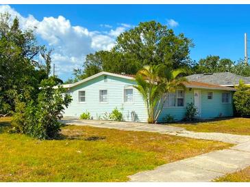 Charming single-story home featuring a well-maintained lawn, mature trees, and a welcoming exterior at 514 Showalter Ave, Punta Gorda, FL 33950