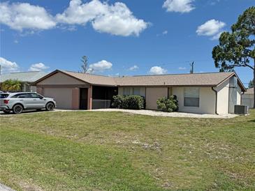 Charming single-story home with a well-manicured lawn and attached two-car garage at 23269 Lehigh Ave, Port Charlotte, FL 33954