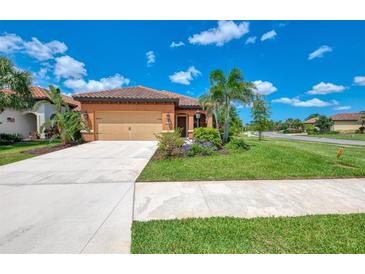 Charming single-story home with a well-manicured lawn, inviting landscape, and attached two car garage at 253 Marcheno Way, Nokomis, FL 34275