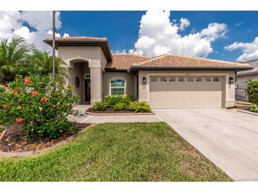 Charming single-story home featuring a tile roof, two-car garage and well-maintained landscaping at 2913 Royal Palm Dr, North Port, FL 34288