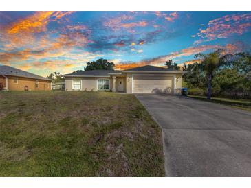 Charming single-story home with a two-car garage, lush lawn, and inviting curb appeal in a quiet neighborhood at 3647 Culpepper Ter, North Port, FL 34286