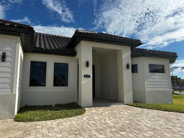 Beautiful front entrance to this property featuring custom brickwork and a modern, covered entryway at 432 Gun Cay Ln, Punta Gorda, FL 33950