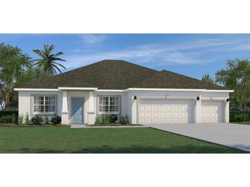 Charming one-story home with a three-car garage, manicured lawn, and classic architectural details at 9453 Fruitland Ave, Englewood, FL 34224