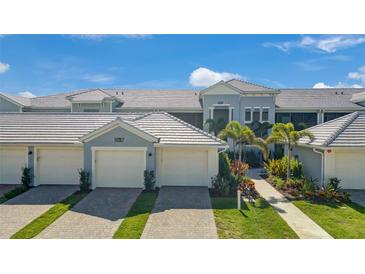 Beautiful exterior elevation of home featuring lush landscaping and attached garage at 14267 Heritage Landing Blvd # 1223, Punta Gorda, FL 33955
