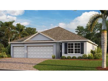 Charming one-story home with a three car garage, neutral paint, and a well-manicured lawn at 25166 Alcazar Dr, Punta Gorda, FL 33955