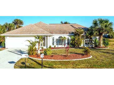 Attractive single-story home with well-manicured landscaping and a charming front yard at 279 Mariner Ln, Rotonda West, FL 33947
