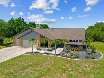 Beautiful single-story home with a well-manicured lawn, elegant landscaping, and a two-car garage at 501 Fairmont Ter, Port Charlotte, FL 33954