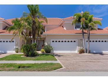 Charming townhome with paver driveway, two-car garage and well-manicured landscaping, creating a welcoming curb appeal at 143 Tropicana Dr # 1012, Punta Gorda, FL 33950