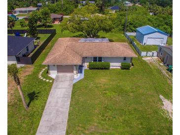 Well-maintained home featuring a long driveway and large grassy front yard at 2119 Pellam Blvd, Port Charlotte, FL 33948