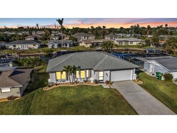 Well-maintained single Gathering home featuring a two-car garage and a manicured front lawn at 3225 Magnolia Way, Punta Gorda, FL 33950