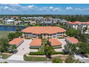 Gorgeous condo building with beautiful tile roof, well maintained landscaping and individual garages at 3314 Wood Thrush Dr # 124, Punta Gorda, FL 33950
