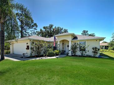 Charming single-story home with a well-manicured lawn and an inviting front entrance at 4092 Troost St, North Port, FL 34288