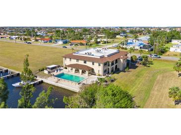 Expansive waterfront home featuring a private pool, boat dock, and stunning architectural design at 1217 Aqui Esta Dr # 5, Punta Gorda, FL 33950