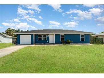 Charming single-story home boasts a well-manicured lawn and attached garage at 2420 Linton Ln, Port Charlotte, FL 33952