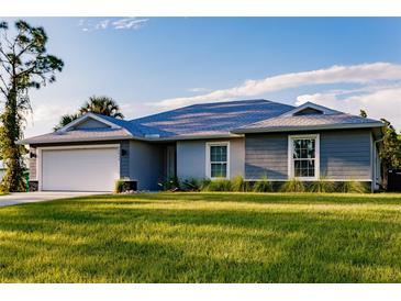 Charming single-story home featuring a well-manicured lawn and attached two-car garage at 16280 Minorca Dr, Punta Gorda, FL 33955