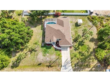 Sprawling home boasts an open layout, screened pool, long driveway and mature landscaping at 2300 Carpenter Ln, North Port, FL 34286