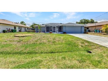 Charming single-story home with a well-manicured lawn and screened entryway at 336 Waterside St, Port Charlotte, FL 33954