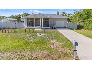 Charming single-story home with a screened-in porch, driveway, and well-maintained lawn and minimal landscaping at 4702 Westwood Dr, Punta Gorda, FL 33982